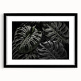 Framed botanical wall art featuring a Monstera plant design set against a black background, highlighting vibrant green leaves in a modern aesthetic. Perfect for home decor.