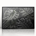 Framed botanical wall art featuring a Monstera plant design in black acrylic, showcasing vibrant green hues and intricate leaf details, perfect for home decor.