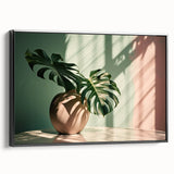 Framed botanical wall art featuring a striking Monstera leaf design, set against a black background, showcasing vibrant greens and intricate details, perfect for home decor.