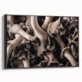Framed canvas wall art featuring a vibrant botanical design with various colorful flowers and mushrooms, displayed against a sleek black background, showcasing artistic details and textures.