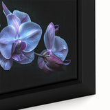 Close-up of a framed botanical wall art piece showcasing vibrant orchids in a colorful design, perfect for enhancing home decor with a touch of nature.