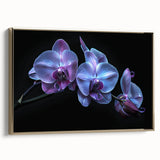 Framed botanical orchid wall art featuring vibrant gold and green hues, elegantly set against a chic backdrop, ideal for enhancing home decor.