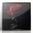 Framed wall art showcasing a botanical rose design with vibrant colors, featuring a sleek black frame, ideal for home decor or floral-themed interiors.