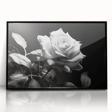 Framed wall art featuring a botanical rose design in vibrant pinks and greens, set in a sleek black frame, perfect for home decor or floral-themed interiors.