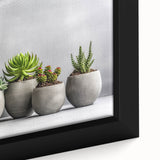 Close-up of a beautifully framed botanical wall art piece showcasing vibrant succulents and floral designs, perfect for adding a touch of nature to home decor.