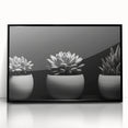 Framed wall art featuring a botanical design of colorful succulents in a sleek black frame, perfect for modern home decor. Ideal for plant lovers and aesthetic interiors.