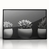 Framed wall art featuring a botanical design of colorful succulents in a sleek black frame, perfect for modern home decor. Ideal for plant lovers and aesthetic interiors.