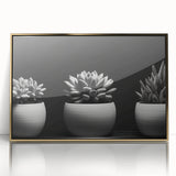 Framed wall art featuring a botanical design of vibrant succulents, elegantly displayed with a gold-acrylic finish, perfect for home decor enhancement.