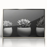 Framed wall art featuring a botanical design of vibrant succulents in various colors, set in a sleek silver frame, perfect for home decor enhancement.
