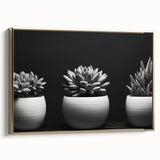 Framed canvas wall art featuring a botanical design of various succulents in vibrant colors, set against a gold background, showcasing a stylish side view.