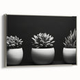 Framed canvas wall art showcasing a stunning botanical design of vibrant succulents, featuring a sleek silver frame, perfect for modern home decor.