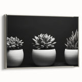 Framed canvas wall art showcasing a stunning botanical design of vibrant succulents, featuring a sleek silver frame, perfect for modern home decor.