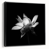 Framed botanical wall art showcasing vibrant tropical flowers on a textured canvas, featuring a sleek black frame, perfect for modern decor.
