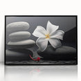 Framed botanical wall art featuring vibrant tropical flowers in a modern black frame. Ideal for home decor, adding a touch of nature and color to any room.
