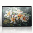 Framed wall art showcasing a vibrant botanical tropical flower design with a black frame, ideal for enhancing home decor with a touch of nature's elegance.