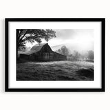 Framed wall art featuring a serene landscape of a rustic barn, with a black mat and sleek black frame, ideal for enhancing home decor and creating a cozy atmosphere.