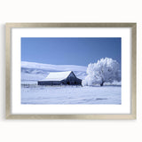 Framed wall art featuring a serene landscape of rustic barns in a silver mat, showcasing warm earth tones and intricate details, perfect for home decor.
