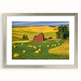 Framed landscape wall art featuring a rustic barn scene, elegantly presented with a silver mat, perfect for enhancing home decor with a touch of countryside charm.