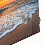 Close-up of a vibrant acrylic glass wall art piece showcasing a serene beach landscape, featuring soft waves, golden sand, and a clear blue sky, perfect for coastal decor.