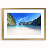 Elegant gold-framed wall art displaying a serene beach landscape, featuring soft blue waves and a clear sky, perfect for enhancing home decor with a coastal theme.