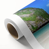 Vibrant rolled canvas wall art depicting a serene beach landscape at sunset, showcasing warm hues of orange, pink, and blue, perfect for home decor.