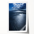 Vibrant rolled print of a serene beach landscape, showcasing soft waves and golden sand under a clear blue sky, ideal for home decor and relaxation.