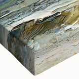 Close-up of a stretched canvas wall art piece showcasing a vibrant beach landscape design, featuring rich blues and sandy tones that evoke a serene coastal atmosphere. Perfect for enhancing home decor with a touch of nature-inspired elegance.