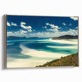 Framed canvas wall art showcasing a serene beach landscape, featuring soft blue and beige tones, with a sleek silver frame adding elegance to any decor. Perfect for enhancing living spaces with a calming coastal vibe.