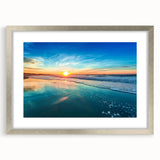 Framed wall art of a serene beach landscape, featuring soft colors and gentle waves, showcased in a sleek silver frame with a mat, ideal for home decor.