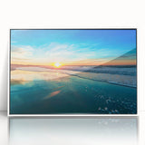 Framed acrylic wall art featuring a serene beach landscape with soft waves and a clear blue sky, highlighted by a sleek white frame, ideal for modern decor.