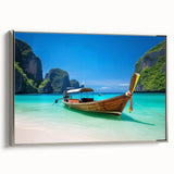 Framed canvas wall art showcasing a serene beach landscape, featuring gentle waves and a vibrant sunset, elegantly presented with a silver frame for a modern touch.