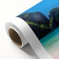 Vibrant rolled canvas artwork showcasing a serene beach landscape with soft waves and a clear blue sky, elegantly packaged in a protective cardboard tube for easy display.