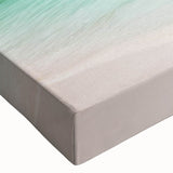 Close-up of a vibrant stretched canvas wall art featuring a serene beach landscape with gentle waves and golden sand, ideal for home decor and relaxation.