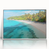 Framed acrylic wall art showcasing a vibrant beach landscape with soft waves and a clear blue sky, elegantly presented with a sleek white frame. Perfect for coastal decor enthusiasts.