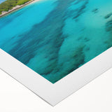 Rolled canvas artwork showcasing a vibrant beach landscape with vivid blues and sandy tones, ideal for coastal decor. Comes securely rolled in packaging for protection.
