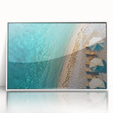 Framed acrylic wall art depicting a serene beach landscape with vibrant blue waters and sandy shores, set against a sleek white frame, perfect for modern decor.