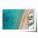 Rolled wall art print showcasing a serene beach landscape with vibrant blues and sandy tones, ideal for home decor, rolled in protective packaging for delivery.