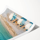 Abstract beach landscape wall art print showcasing vivid blues and sandy tones, elegantly rolled and ready for display, perfect for enhancing coastal-themed decor.