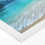 Vibrant rolled canvas artwork showcasing a serene beach landscape with blue ocean waves and golden sand, perfect for home decor or coastal-themed interiors.