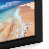 Framed canvas wall art showcasing a vibrant beach landscape with vivid blue skies and golden sand, adding a serene coastal touch to any room decor.