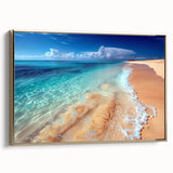Framed canvas wall art showcasing a serene beach landscape with vibrant blue skies and golden sands, elegantly displayed from a side view against a neutral background.