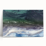 Stretched canvas artwork showcasing a serene beach landscape with vibrant colors, ideal for home decor, leaning against a wall, evoking calmness and relaxation.