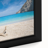 Framed canvas wall art showcasing a serene beach landscape with golden sands and tranquil blue waves, perfect for enhancing home decor aesthetics.