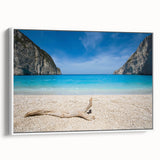 Framed canvas wall art showcasing a serene beach landscape with soft blue skies and gentle waves, elegantly displayed with a white frame, perfect for coastal-themed decor.