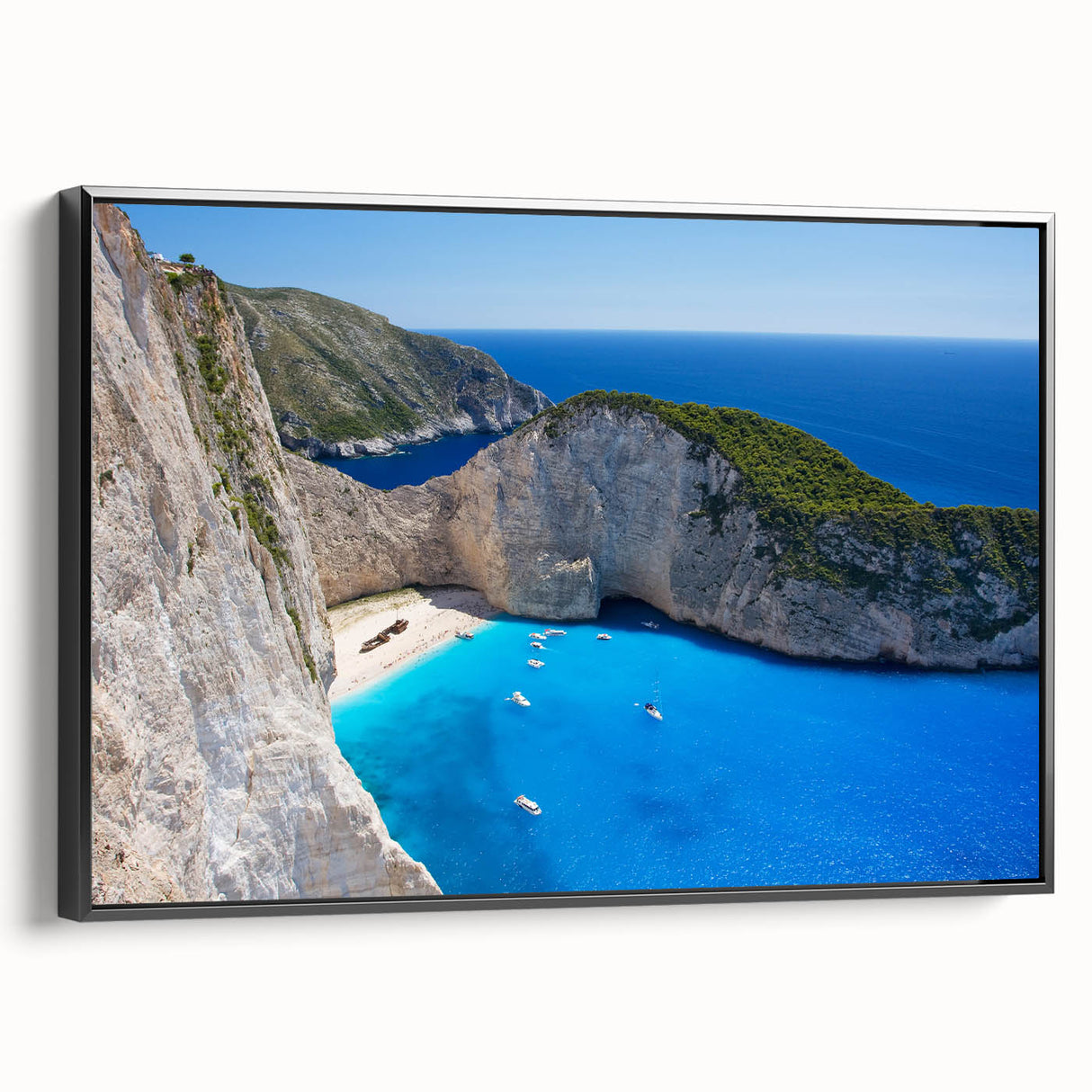 Framed canvas wall art showcasing a serene beach landscape with vibrant colors, featuring a black frame and side view angle that highlights its sleek design. Ideal for home decor enthusiasts looking to enhance their living space with coastal themes.
