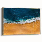 Framed canvas wall art depicting a vibrant beach landscape with golden accents, showcasing serene ocean waves and a clear sky, perfect for home decor.