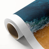 Vibrant rolled canvas wall art featuring a serene beach landscape with soft waves and a colorful sunset, perfect for enhancing any coastal-themed decor.