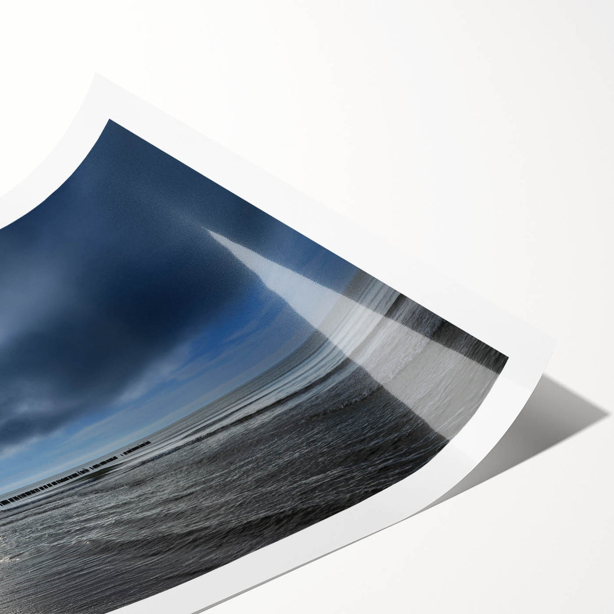 Vibrant rolled print showcasing a serene beach landscape with soft waves and a colorful sunset, perfect for home decor or artistic wall displays.