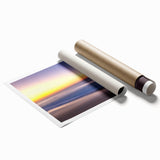 Rolled print of a serene beach landscape featuring soft waves and golden sands, ideal for home decor. The artwork captures calming blues and warm earth tones, perfect for enhancing any living space.