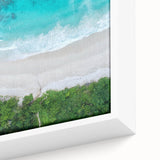 Close-up of a framed canvas wall art piece depicting a serene beach landscape, featuring vibrant colors and intricate details, perfect for home decor.